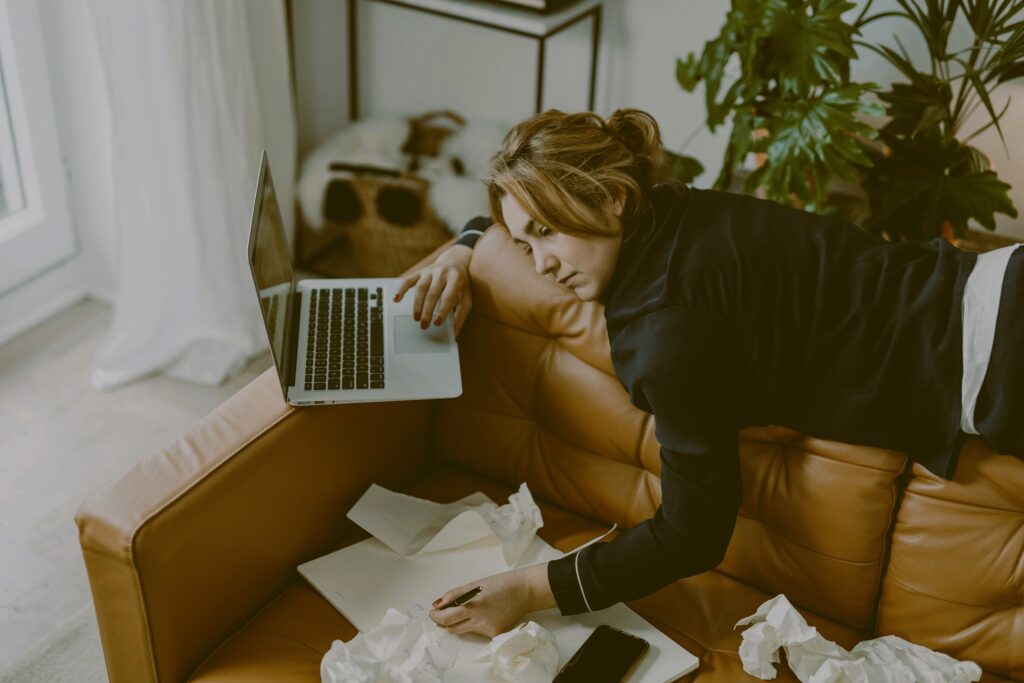 Person with laptop looking mentally drained
