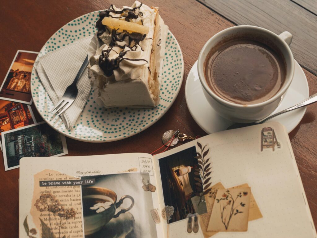 aesthetic journaling spread with coffee, cake, photos, and decorative scrapbook elements